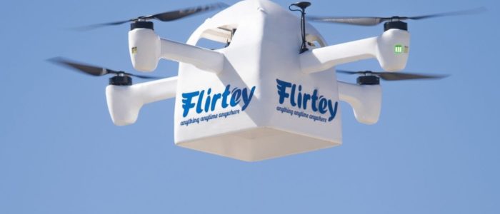 Delivery drone on sky marked "Flirtey"
