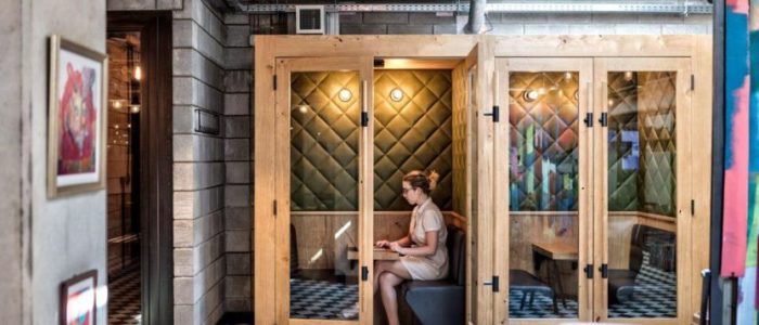 Woman Types in a Small Booth in Office Workspace (Photo Credit: Mindspace on Forbes))