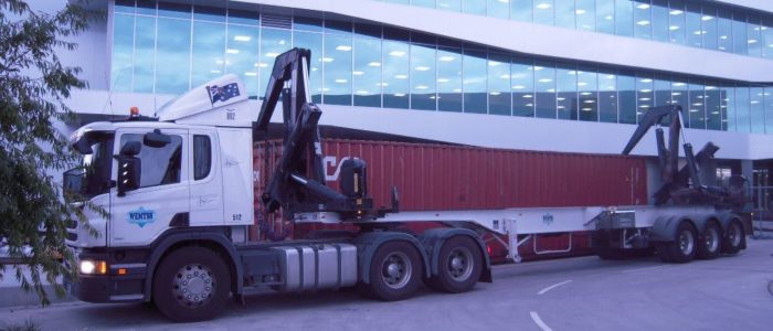 container offload: furniture truck in front of an office with windows