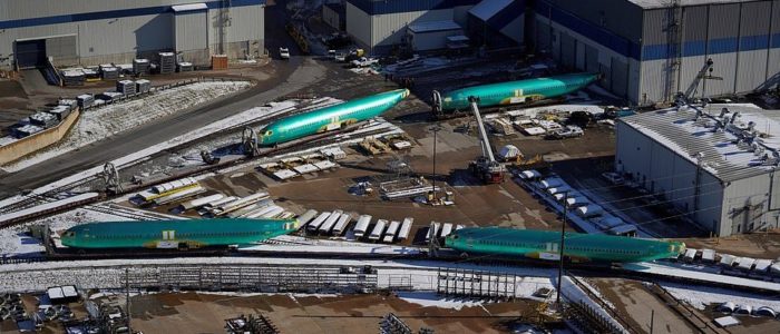 Boeing aircraft lined up on concrete and also on railway sidings